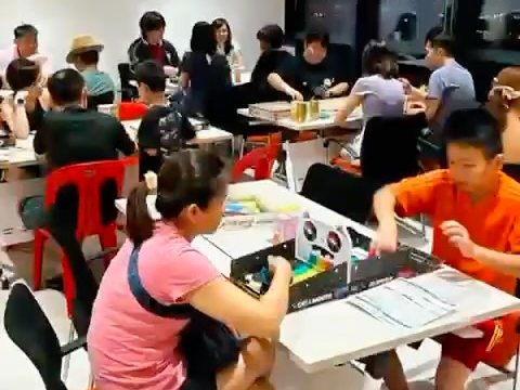 Youths playing board games around tables at Buangkok CC