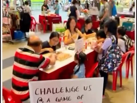 Residents playing chess at tables in Sengkang Grand Mall during the flea market